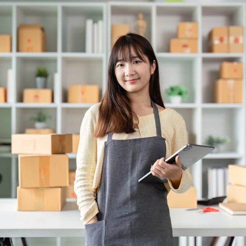 portrait-of-a-young-woman-entrepreneur-in-her-home-office-with-shipping-boxes-and-digital-tablet.jpg